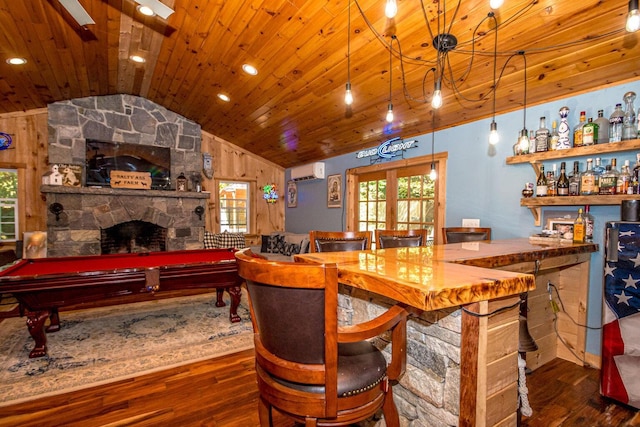 bar with dark hardwood / wood-style floors, a wall mounted AC, pendant lighting, lofted ceiling, and pool table