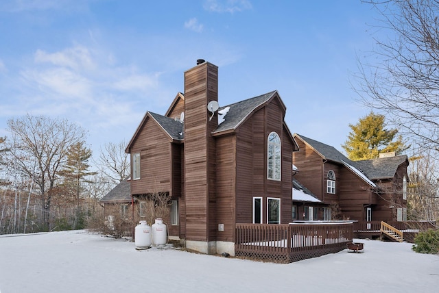 snow covered house with a deck