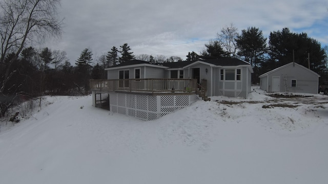 snow covered rear of property featuring a deck