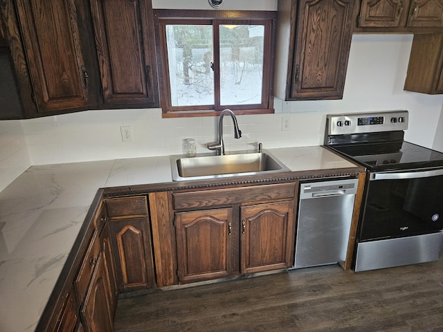 kitchen featuring dishwasher, sink, electric range, dark hardwood / wood-style floors, and dark brown cabinetry