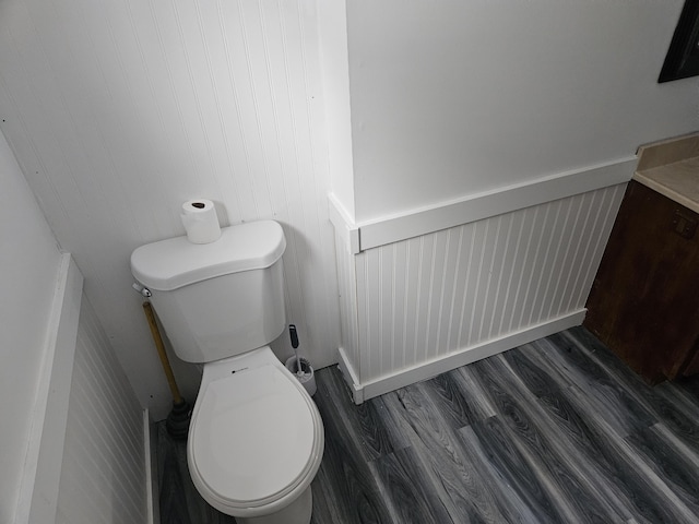 bathroom with hardwood / wood-style flooring and toilet