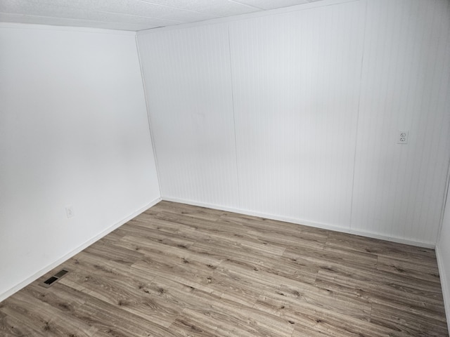 unfurnished room featuring hardwood / wood-style flooring