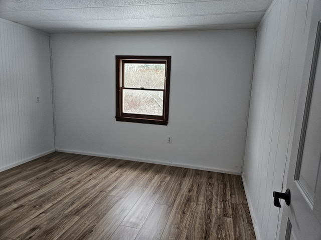 spare room with dark wood-type flooring