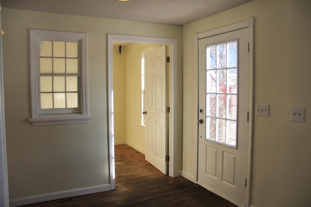 entryway featuring dark hardwood / wood-style flooring and a textured ceiling