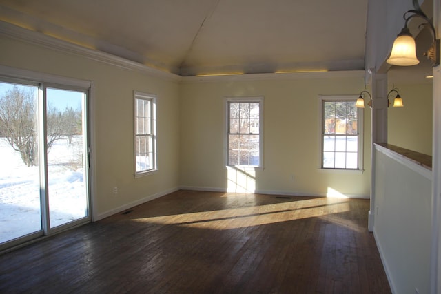 unfurnished room featuring dark hardwood / wood-style floors, lofted ceiling, and ornamental molding