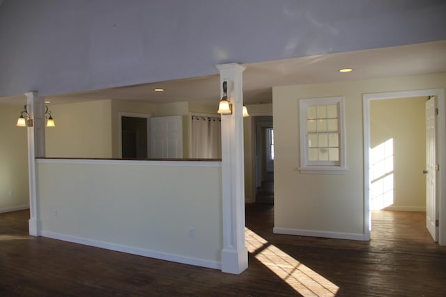 unfurnished room with a chandelier and dark hardwood / wood-style floors