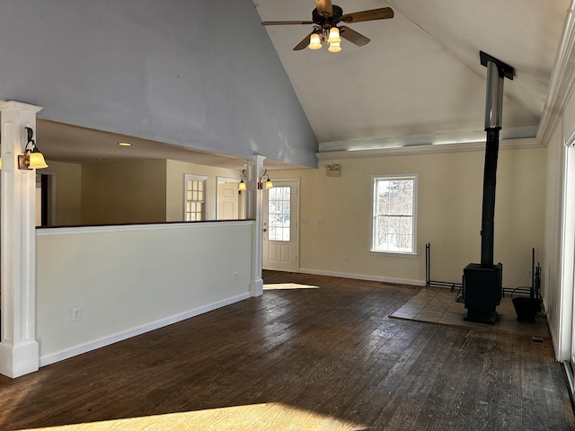 unfurnished living room with a wood stove, high vaulted ceiling, ceiling fan, and dark wood-type flooring