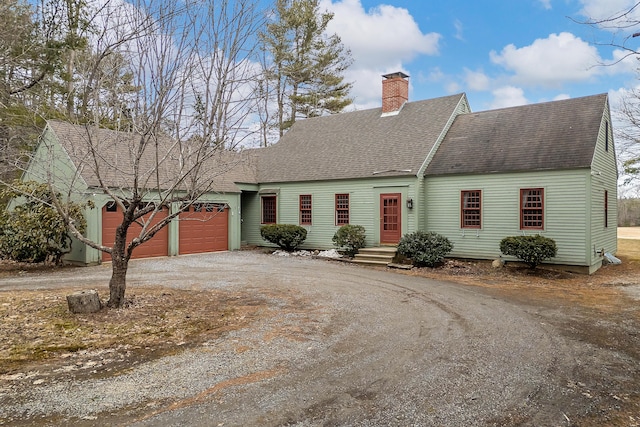 35 Cushman Rd, Nobleboro, ME 04555 - cape cod house with a chimney, roof with shingles, an attached garage, and dirt driveway