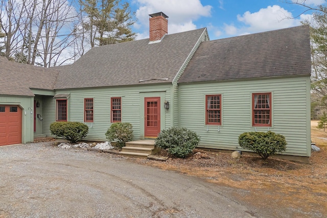 35 Cushman Rd, Nobleboro, ME 04555 - new england style home featuring driveway, a shingled roof, a garage, and a chimney
