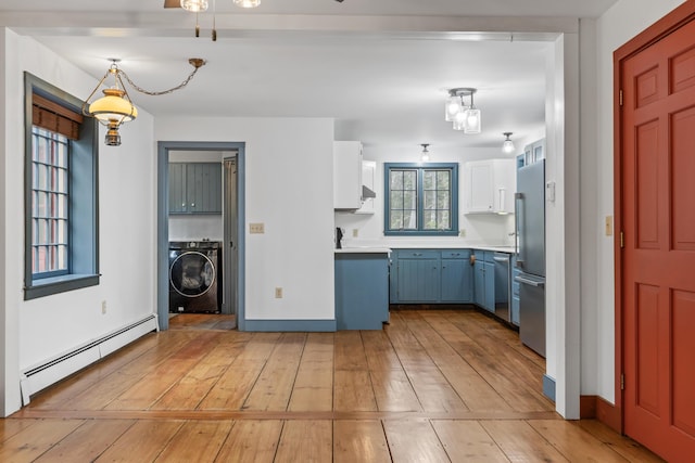 35 Cushman Rd, Nobleboro, ME 04555 - kitchen with light countertops, light wood-type flooring, stainless steel appliances, washer / dryer, and a baseboard radiator