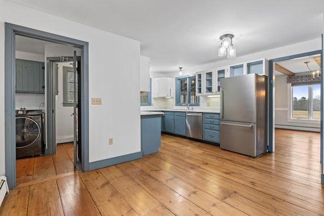 35 Cushman Rd, Nobleboro, ME 04555 - kitchen with a sink, light wood finished floors, baseboard heating, washer / dryer, and stainless steel appliances