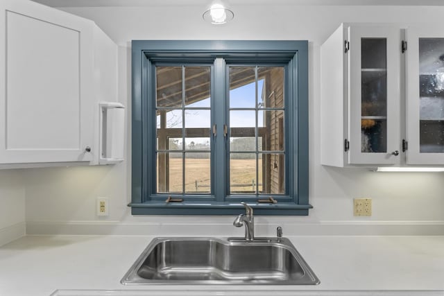 35 Cushman Rd, Nobleboro, ME 04555 - kitchen featuring glass insert cabinets, white cabinetry, light countertops, and a sink