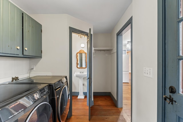 35 Cushman Rd, Nobleboro, ME 04555 - laundry room featuring a sink, wood-type flooring, baseboards, independent washer and dryer, and cabinet space