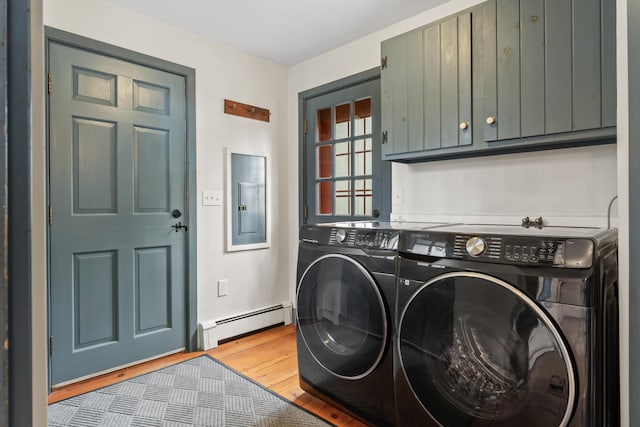35 Cushman Rd, Nobleboro, ME 04555 - clothes washing area with a baseboard radiator, light wood-style flooring, cabinet space, and washer and dryer