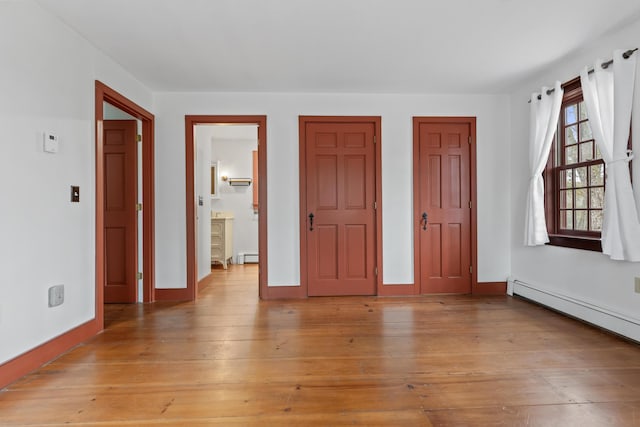 35 Cushman Rd, Nobleboro, ME 04555 - unfurnished bedroom featuring baseboards, light wood-style floors, and a baseboard heating unit