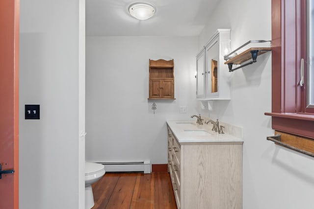 35 Cushman Rd, Nobleboro, ME 04555 - bathroom featuring toilet, wood finished floors, a baseboard heating unit, and vanity