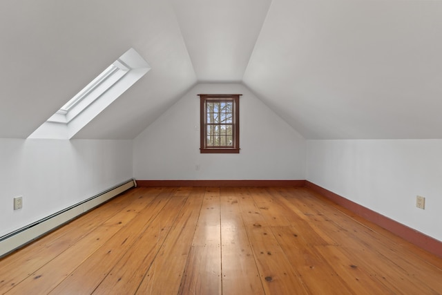 35 Cushman Rd, Nobleboro, ME 04555 - bonus room featuring baseboards, baseboard heating, lofted ceiling with skylight, and wood-type flooring