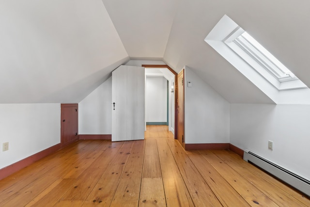 35 Cushman Rd, Nobleboro, ME 04555 - bonus room featuring baseboards, vaulted ceiling with skylight, a baseboard heating unit, and light wood finished floors