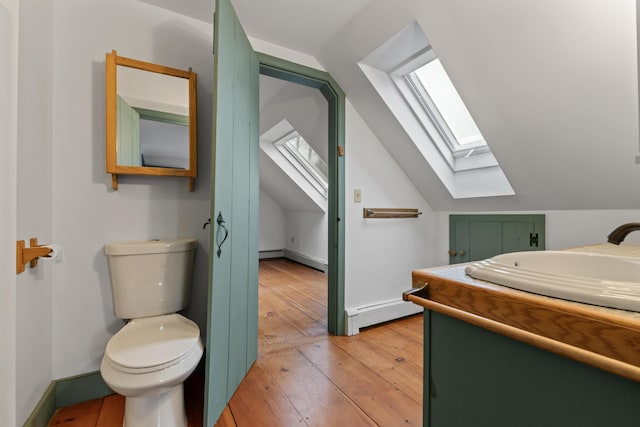35 Cushman Rd, Nobleboro, ME 04555 - bathroom with wood-type flooring, lofted ceiling with skylight, and baseboard heating