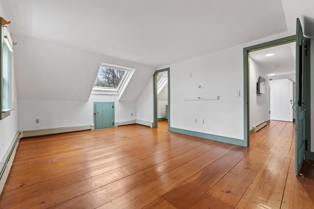 35 Cushman Rd, Nobleboro, ME 04555 - additional living space with light wood finished floors, vaulted ceiling with skylight, and a baseboard heating unit