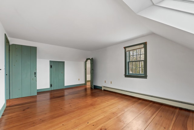 35 Cushman Rd, Nobleboro, ME 04555 - additional living space with vaulted ceiling, baseboard heating, and hardwood / wood-style flooring