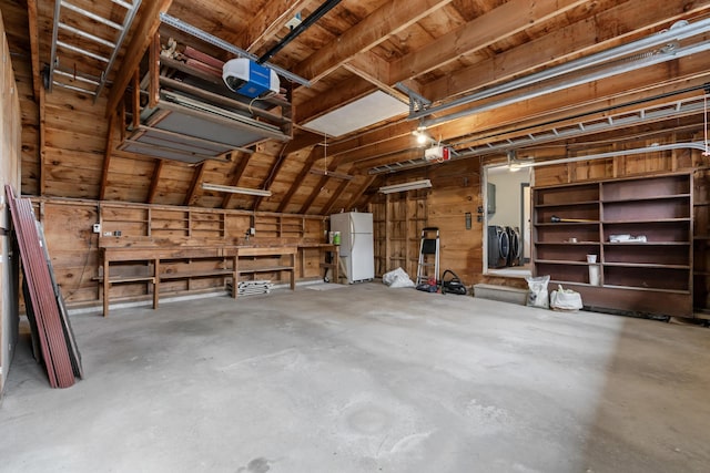 35 Cushman Rd, Nobleboro, ME 04555 - garage featuring freestanding refrigerator and a garage door opener