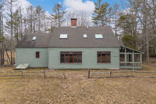 35 Cushman Rd, Nobleboro, ME 04555 - rear view of house featuring a chimney, a shingled roof, and a sunroom