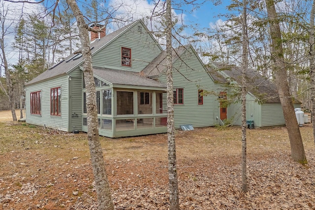35 Cushman Rd, Nobleboro, ME 04555 - rear view of property featuring a sunroom and roof with shingles