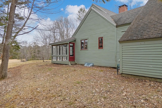35 Cushman Rd, Nobleboro, ME 04555 - view of side of property featuring a shingled roof, a sunroom, and a chimney