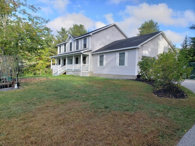 rear view of house featuring a lawn and a porch