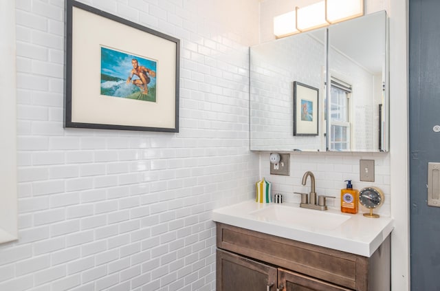 bathroom with tasteful backsplash and vanity