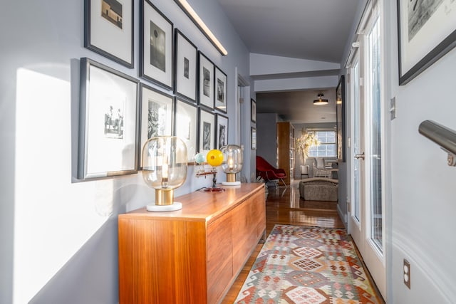 hallway featuring lofted ceiling and hardwood / wood-style floors