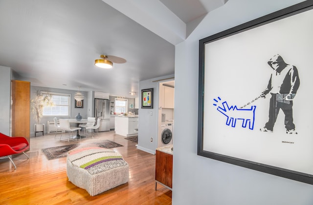 interior space with washer / clothes dryer and hardwood / wood-style flooring