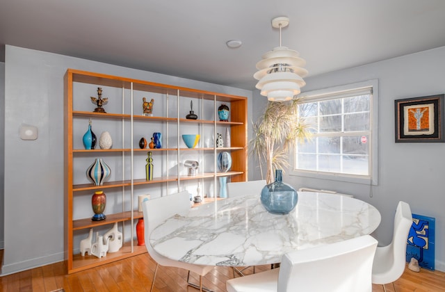 dining space with a chandelier and light hardwood / wood-style floors