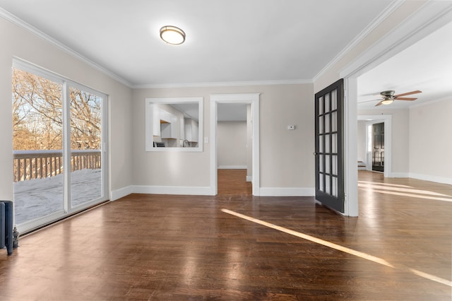 spare room with dark wood-type flooring, ceiling fan, and crown molding