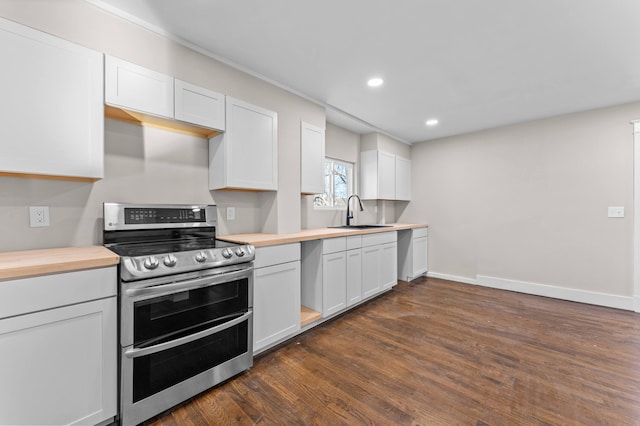 kitchen featuring double oven range, white cabinets, sink, dark hardwood / wood-style floors, and butcher block countertops