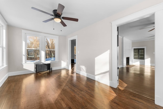 interior space featuring ceiling fan, dark hardwood / wood-style flooring, and radiator heating unit