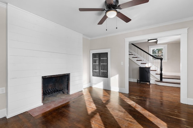 unfurnished living room with a fireplace, ornamental molding, dark wood-type flooring, and radiator