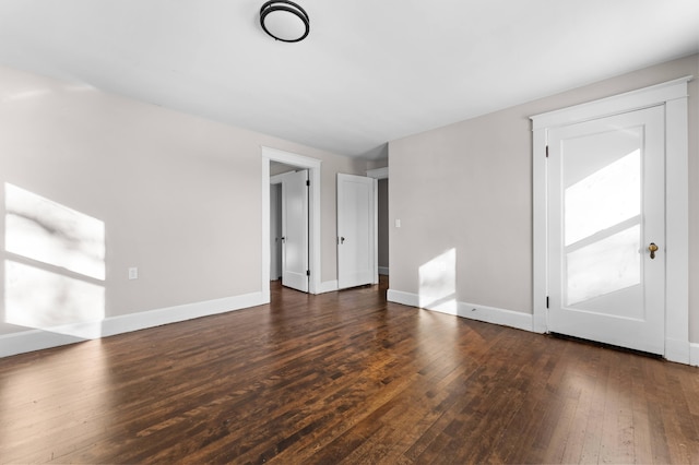 unfurnished living room with dark hardwood / wood-style floors