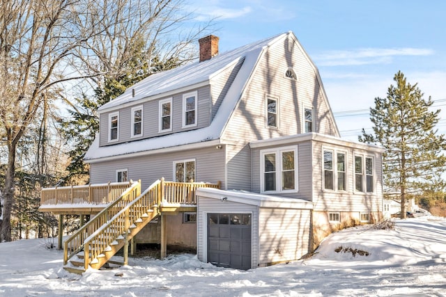 view of front of house with a garage and a deck