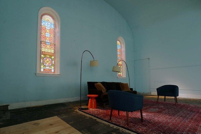 sitting room featuring hardwood / wood-style floors and lofted ceiling