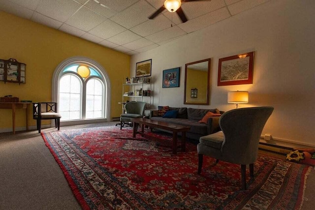 living room featuring carpet, ceiling fan, and a baseboard heating unit