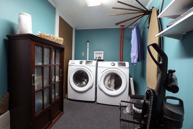 laundry room featuring dark colored carpet and washer and clothes dryer