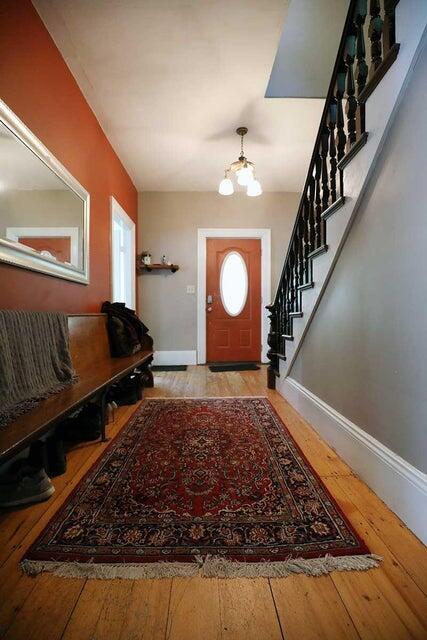 foyer with light hardwood / wood-style floors and a notable chandelier