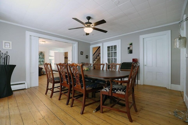 dining room with baseboard heating, ceiling fan, light hardwood / wood-style floors, and ornamental molding