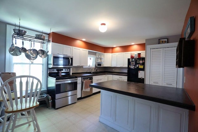 kitchen with white cabinets, sink, and appliances with stainless steel finishes