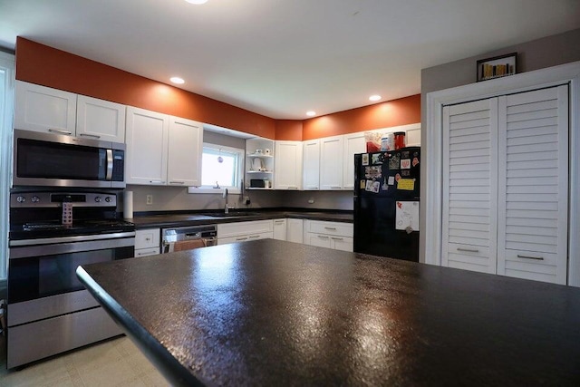 kitchen featuring sink, white cabinets, and stainless steel appliances