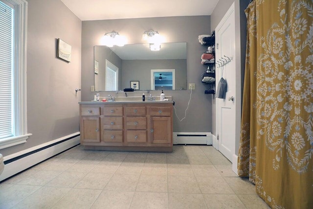 bathroom with vanity, tile patterned floors, and a baseboard heating unit