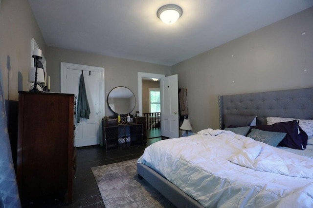 bedroom with dark hardwood / wood-style floors