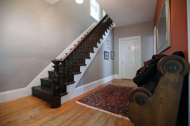 stairs featuring hardwood / wood-style floors